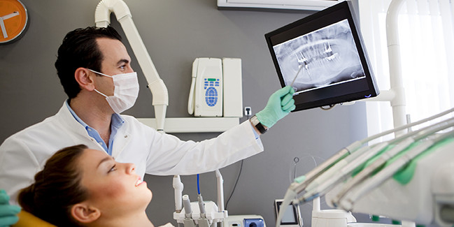 Dentist and patients using high tech technology