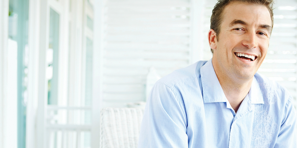 Man smiling after a tooth extraction