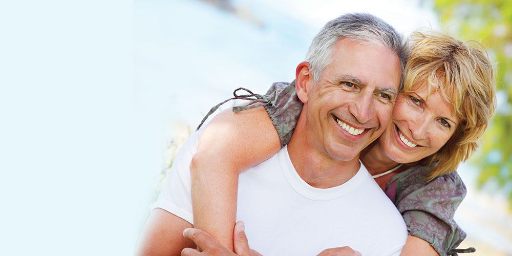 Couple with healthy smiles and crown dental work